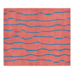 A square coral pink rug with a textured surface and horizontal wavy blue stripe pattern, shown flat against a white background.