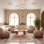 A beautifully styled living room featuring a pink and cream modular sofa arrangement, a central wooden coffee table, a patterned area rug, and a large potted bamboo plant.