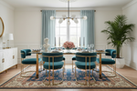Modern dining room with blue rug, with teal chairs, gold legs, and a large window.
