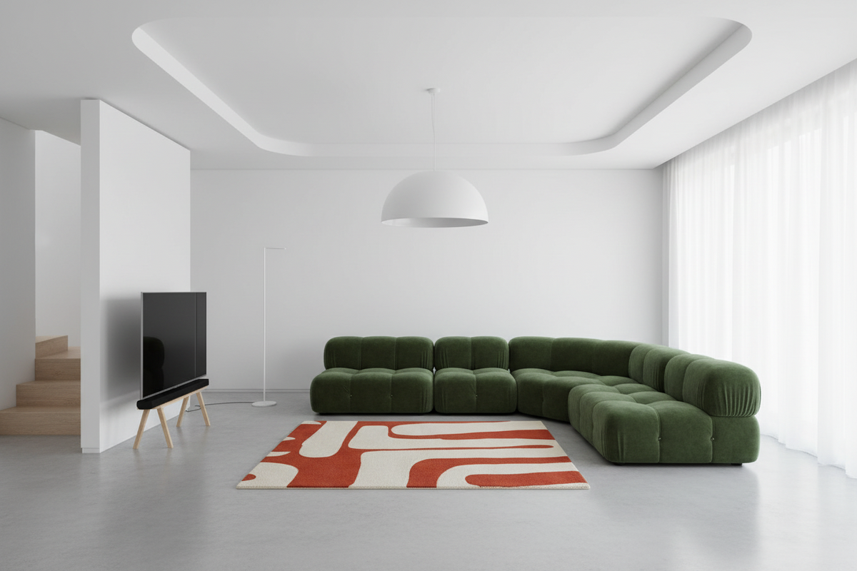 Modern living room with a green sectional sofa, red and white rug, and minimal decor.