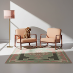 Two blush pink armchairs with copper-toned frames are arranged on a patterned rug in a sunlit room, with a small brown dog sitting on the left chair. A matching pink floor lamp stands to the left.