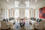Modern living room with beige sofas, a coffee table, and decorative blue rug.