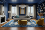 Luxurious living room with blue rug, walls, a gray sofa, yellow armchair, and decorative rug.