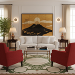 A styled living room featuring a large framed Japanese triptych wall art piece of Mount Fuji with a golden sun and black mountain silhouette. The artwork is displayed on a white wall above a white sofa, flanked by two red armchairs, a patterned rug, and potted plants.