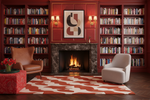 Cozy living room with bookshelves, red rug, fireplace, and armchairs.