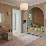 A beautifully styled interior room with warm wood paneling, a pink patterned rug, a green and white striped daybed in an arched alcove, and a hanging drum pendant light.