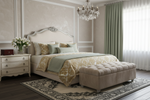 Luxurious bedroom with a bed, persian rug, ottoman, and chandelier.