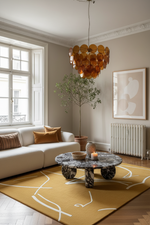 Modern living room with a marble coffee table, white sofa, and decorative rug.