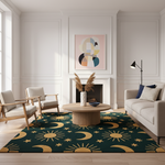 A large area rug with a gold sun and moon and star pattern on a dark teal background, styled in a bright, modern living room with a round wooden coffee table, two mid-century modern armchairs, a light beige sofa, and a minimalist abstract painting on the wall.