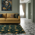 A dark teal area rug with a gold celestial sun and moon pattern is styled in a modern living room setting on a gray patterned tile floor, positioned in front of a mustard yellow sofa.