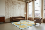 Modern living room with a brown sofa, armchair, and decorative rug featuring sun designs.