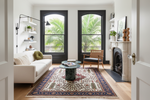 Living room with a white sofa, coffee table, and decorative rug.