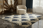 Decorative fan rug with leaf pattern in a room with a chair and wall art.