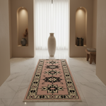A long runner rug with a pink base and a black, beige, and white geometric star pattern, styled in a modern, minimalist hallway with marble floors and a large white vase in the center.
