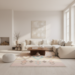 A modern living room featuring a light beige sectional sofa, a geometric patterned area rug, a dark wood coffee table, and a large abstract canvas print on the wall.