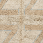 Close-up of a plush, textured rug featuring a Union Jack design in beige and cream with light blue outlines.