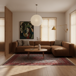 A modern living room featuring a brown sectional sofa, a red patterned area rug, a round wooden coffee table, and a large abstract painting on the wall.