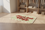 Decorative rug with 'Trust but Verify' text on a wooden floor.