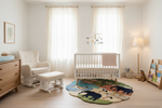 Nursery room with crib, rocking chair, and rug featuring animals.