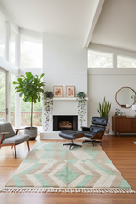 Modern living room with a geometric green shaggy rug, Eames lounge chair, and large windows.