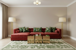 Living room with a red sofa, decorative pillows, and a patterned rug.