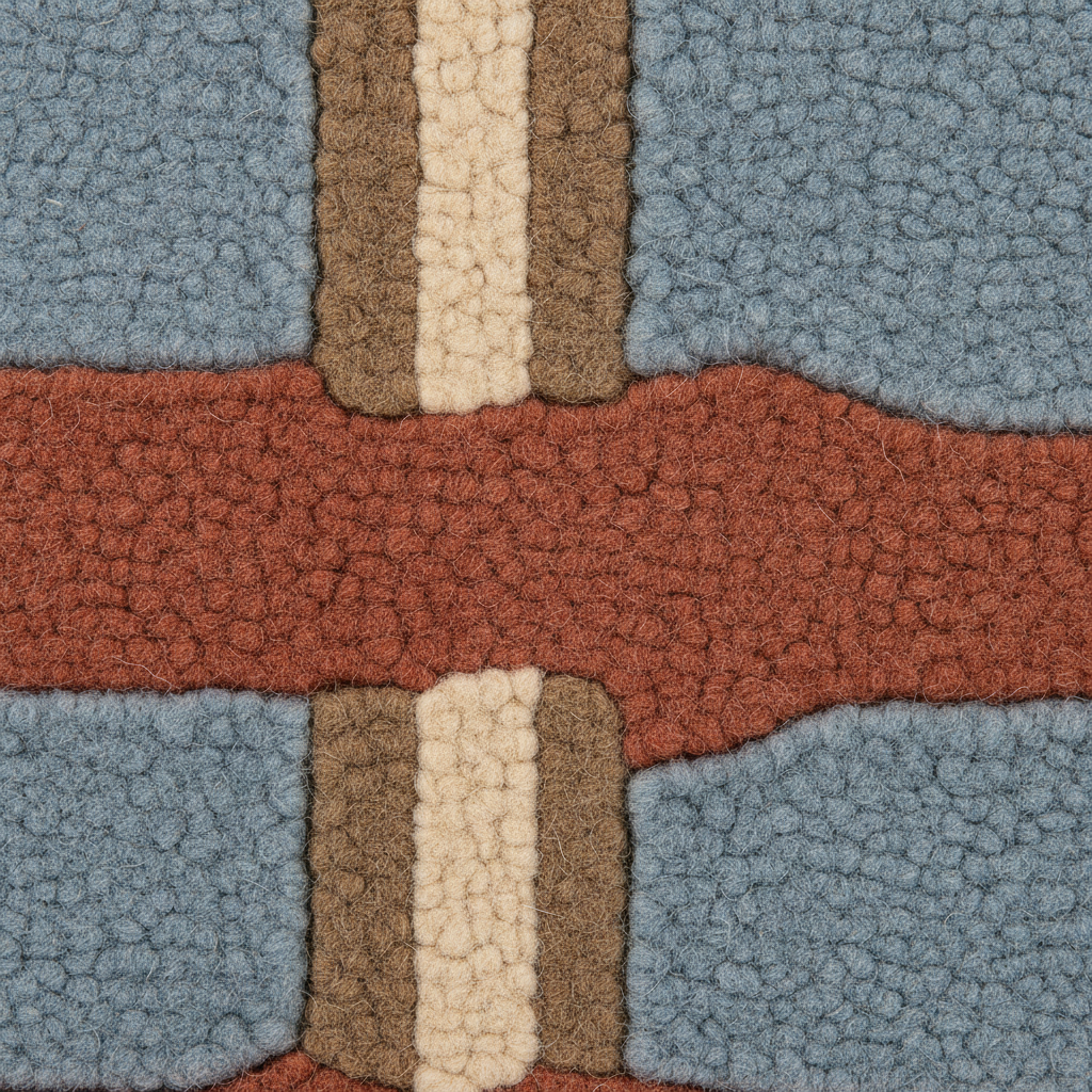 A close-up of a textured, looped pile fabric or rug with a geometric pattern in dusty blue, terracotta red, tan, and cream.