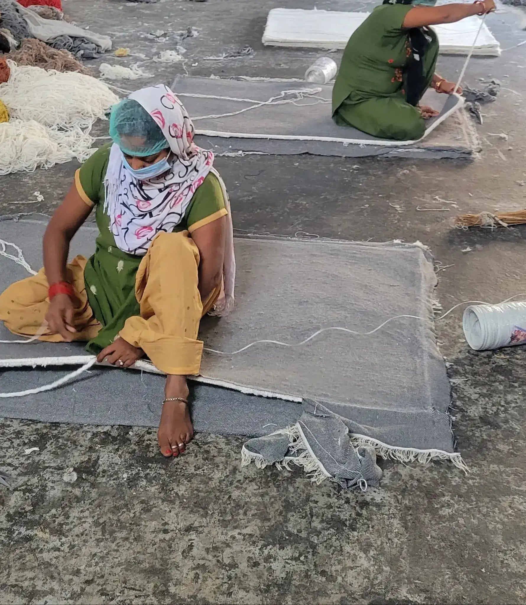 Artisan handcrafting a wool rug, showcasing the intricate process of creating large area rugs for living room use. The image highlights the detailed craftsmanship involved in producing high-quality living room area rugs.