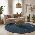 Living room with a blue round jute rug, beige sofa, and decorative plants.
