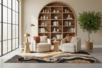 A styled interior scene with two cream armchairs, small wooden side tables, a tall floor lamp, a large arched wooden bookshelf filled with books and vases, a patterned area rug, and a potted tree by a large window.