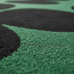 Close-up of a green and black hand tufted wool rug