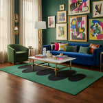 Modern living room with a blue sofa, green armchair, and colorful abstract art on the wall.
