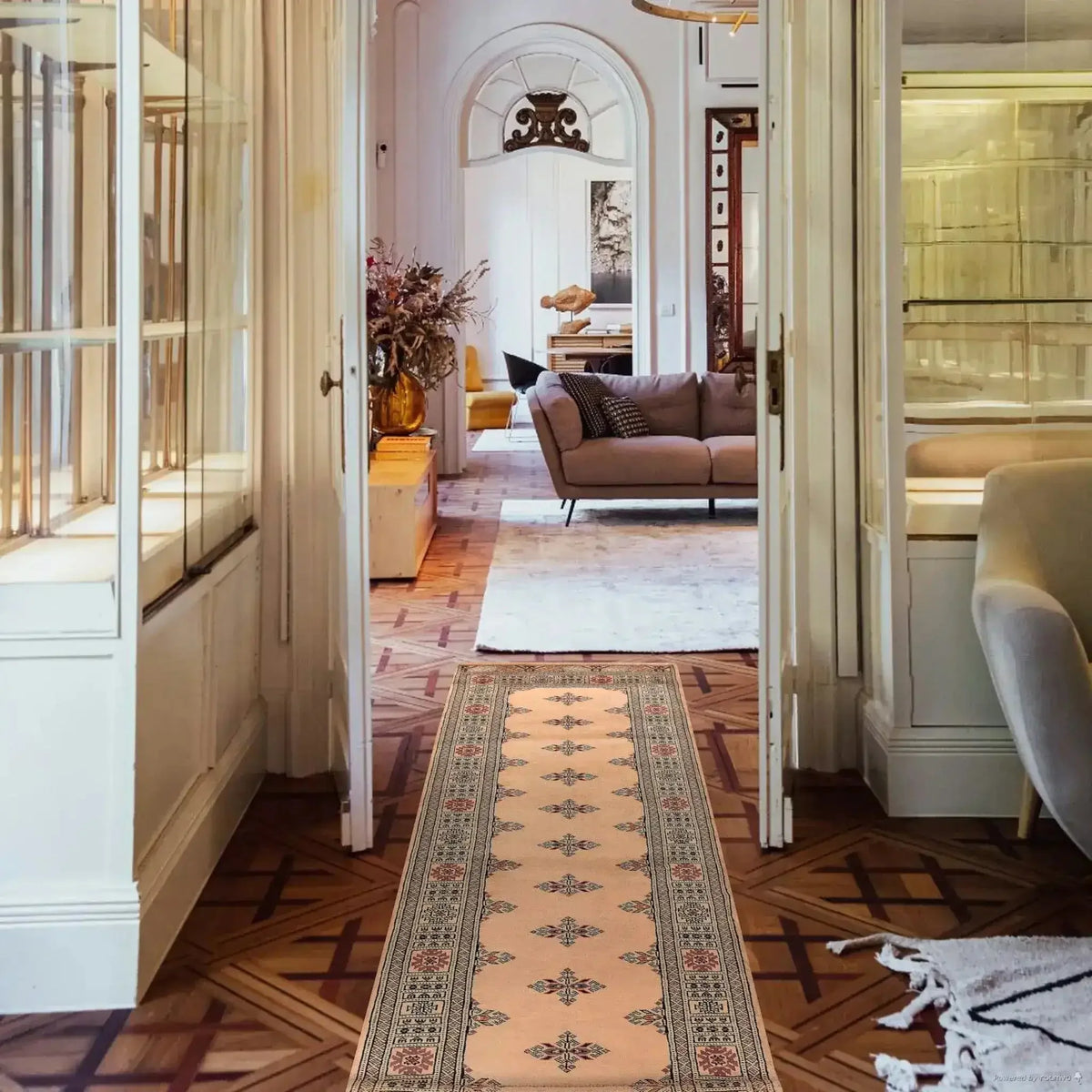Living room with a patterned rug, sofa, and decorative elements.