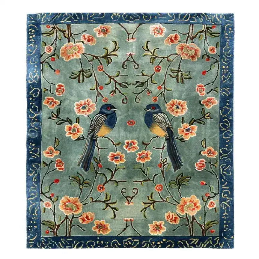 The Feathered Melody Hand-Tufted Rug showcases a stunning design with vibrant birds and floral patterns against a serene background. Ideal for large living room rugs or dining room decor, this wool rug adds elegance to any living room area.