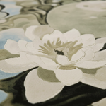 A close-up of a large white lotus flower with layered petals and muted green and black shading, set against a soft abstract background with pale blue and gray tones.