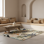 A rectangular area rug with an abstract leopard and floral pattern in beige, navy, green, and cream, styled in a modern minimalist living room with a wooden coffee table and built-in bench seating.