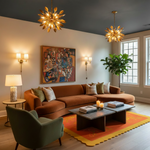 A styled living room interior featuring a large rust-brown sectional sofa, a green armchair, a yellow and orange patterned rug, two gold leaf chandeliers, and a dark gray ceiling.
