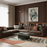 A modern living room featuring a large brown sectional sofa with accent pillows, a dark green marble coffee table, a patterned area rug, and a framed abstract art print on a dark wood-paneled wall.