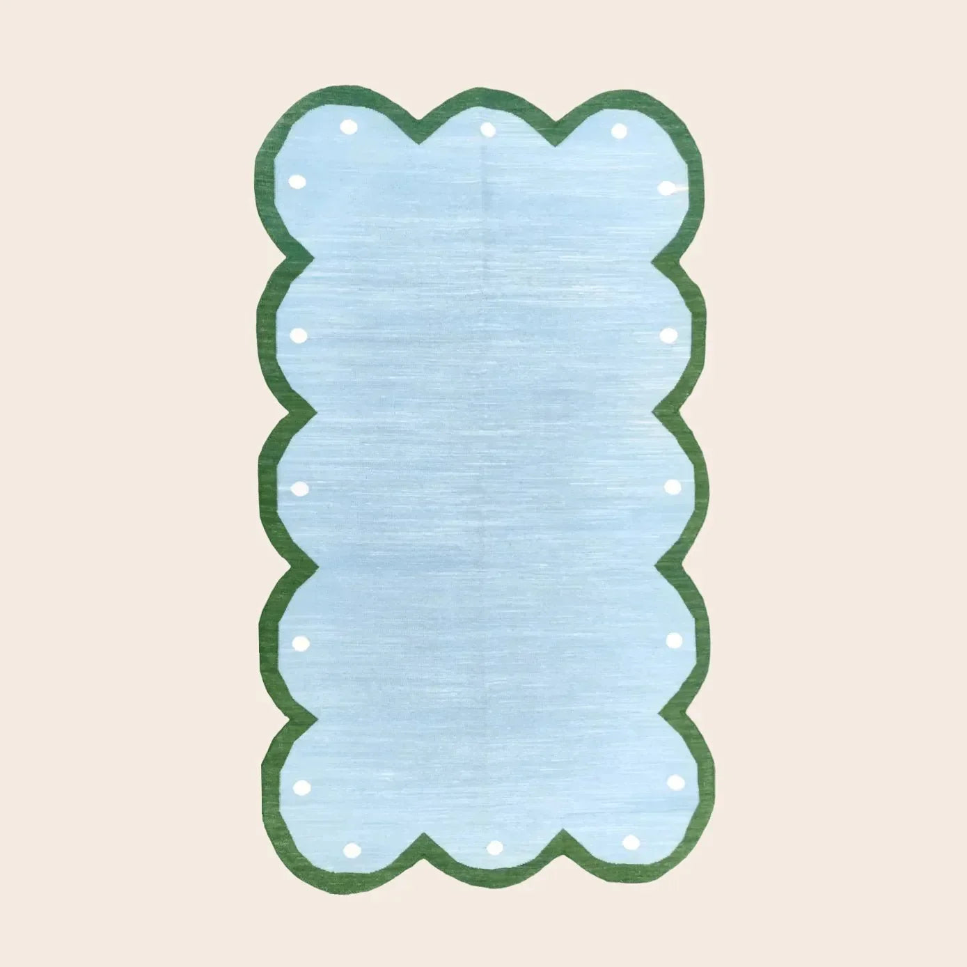 The "Handmade Scalloped Dotted Cotton Rug - 2' x 3'" features a charming scalloped edge and dotted pattern, offering a soft, durable, and stylish addition to any room.