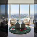 A luxury living room setup with two cream armchairs, striped side tables, and a round green holiday-themed rug, all set against a large window overlooking a city skyline and park.