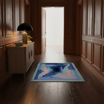 A rectangular area rug with an abstract geometric design in shades of blue, pink, and light blue, placed on a dark wood floor in a classic hallway with wood-paneled walls and a sideboard.