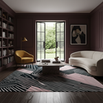 A styled interior room with dark burgundy walls, a curved cream sofa, a mustard yellow armchair, a low stone coffee table, a large black, white, and pink geometric area rug, bookshelves, and open French doors looking out to a garden.