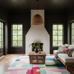 A styled living room interior featuring a large abstract multicolor area rug, a woven rattan pendant light, a wicker coffee table, a white upholstered sofa with colorful pillows, and a white chimney breast against dark wood-paneled walls.
