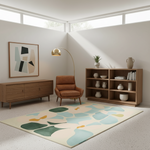 A styled mid-century modern living room featuring a large abstract pattern area rug in cream, teal, and olive green, alongside a brown leather armchair, a wooden credenza, a floor lamp, and a wooden bookshelf.