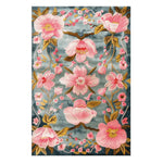 Magnolia Blossom rug pattern of pink blossom branches and a bird against a blue-grey backdrop
