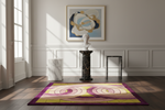 A rectangular area rug with a purple, yellow, and pink abstract spiral pattern is displayed on a dark wood floor in a styled room setting with a marble bust, pedestals, and wall paneling.