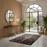 A rectangular area rug with a dark navy background and a coral-red floral pattern is styled in a modern interior room with a slatted wood wall, console table, mirror, and large arched window.