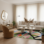 A modern living room featuring a white sofa, a round tan armchair, a colorful abstract-patterned area rug, and neutral beige curtains and walls.
