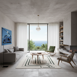 A modern living room with a concrete ceiling and floor, featuring a gray sofa, a round coffee table, a patterned rug, a green accent chair, and a large window overlooking the ocean.