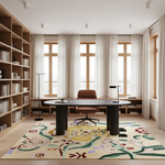 A large, colorful area rug with a whimsical floral and abstract pattern in yellow, green, red, and blue, styled in a bright, modern home office with a wooden desk, leather chair, and bookshelves.