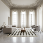 Modern living room with a geometric rug, sofa, and chairs in a bright room.